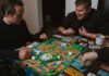 “뇌 건강 지키기, 생활 속 작은 실천에서 시작된다” two men playing a game of monopoly on a table
